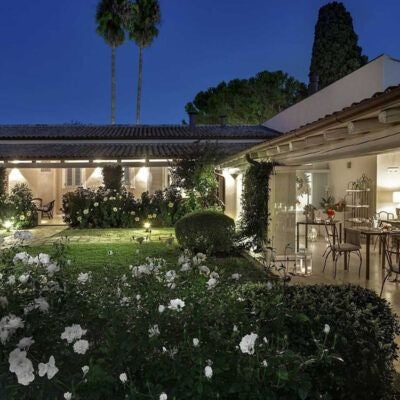 Elegant Sicilian countryside villa with lush gardens, stone walls, and Mediterranean architecture reflecting timeless luxury near Syracuse