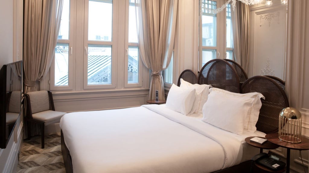 Luxurious superior city room at The Stay Bosphorus, featuring modern decor, plush bedding, and expansive windows overlooking Istanbul's cityscape