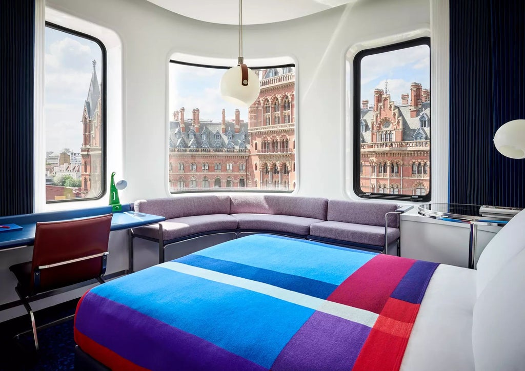 Luxurious modern hotel room at The Standard in London, featuring minimalist design, floor-to-ceiling windows, and sleek contemporary furnishings with city skyline view