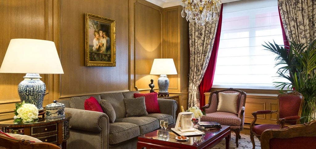 Elegant Parisian boutique hotel facade with ornate windows, wrought-iron balconies, and classic limestone architecture near Champs-Élysées.