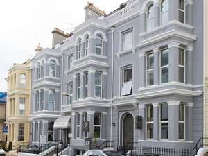 Elegant exterior of a historic hotel with Victorian architectural details, located in a scenic coastal city in the United Kingdom