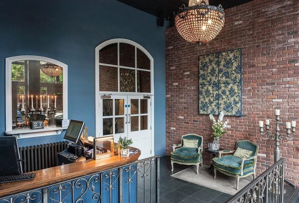 Boutique hotel exterior with elegant red brick facade, large windows, and classic Manchester architectural style in United Kingdom