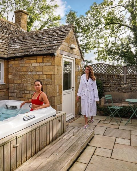 Luxurious hot tub courtyard suite at Scenset House Hotel & Spa, featuring elegant modern decor, warm lighting, and intimate outdoor relaxation space in the United Kingdom