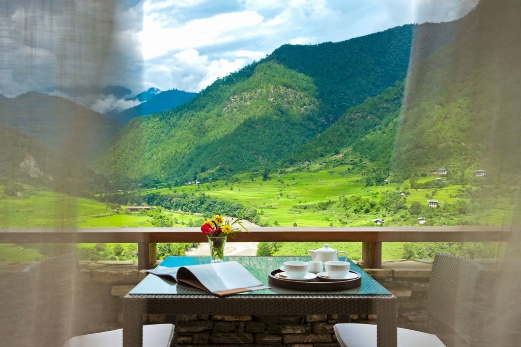 Luxurious COMO Uma Punakha hotel nestled in Bhutan's lush mountain landscape, showcasing traditional architecture with elegant white walls and wooden accents