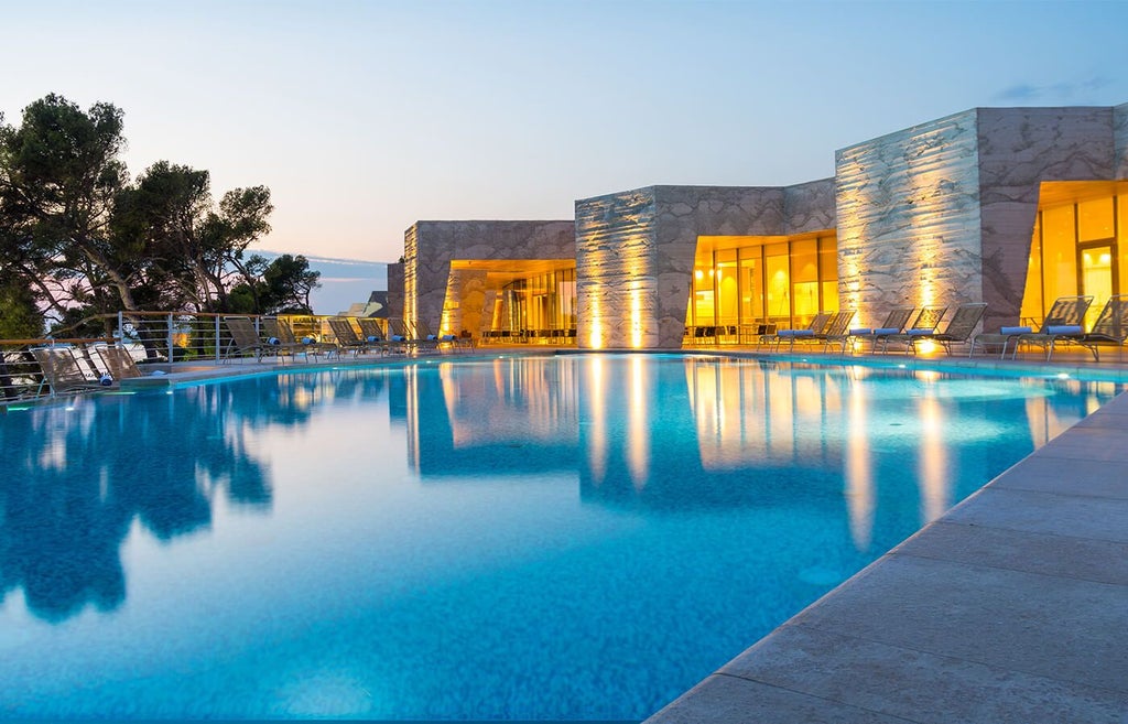 Luxury seaside resort with modern architecture, nestled along the Adriatic coastline near Šibenik, featuring sleek white buildings and panoramic ocean views