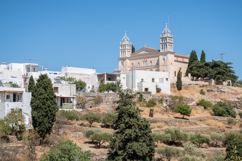 Rocky Byzantine trail winding through rugged Greek landscape, ancient stone path, lush olive groves, azure Aegean Sea glimpsed in distant horizon, golden sunlight illuminating weathered stone steps