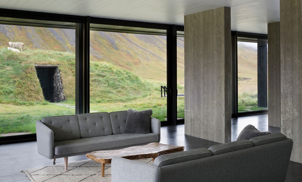 Luxurious geothermal spa with steaming blue waters nestled against rugged Icelandic volcanic landscape, guests relaxing amid misty thermal pools