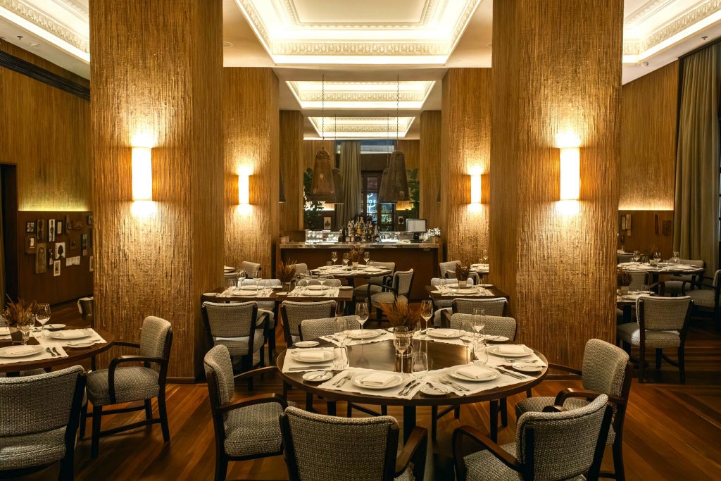 Luxurious Fasano hotel lobby in Salvador, Brazil, with elegant modern design, sleek marble floors, and warm tropical lighting casting a golden glow