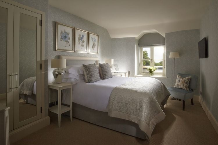 Luxurious hotel room at Dormy House Hotel & Spa, featuring elegant decor, plush bedding, and sophisticated design with soft neutral tones and modern amenities