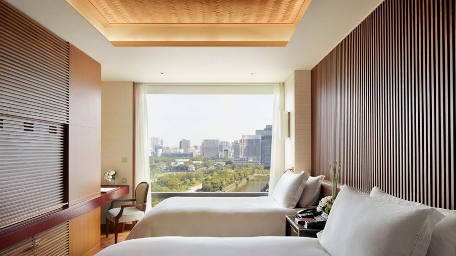 Luxurious Grand Premier Suite at The Peninsula Tokyo, featuring elegant contemporary design, city skyline view, and premium Japanese-inspired furnishings