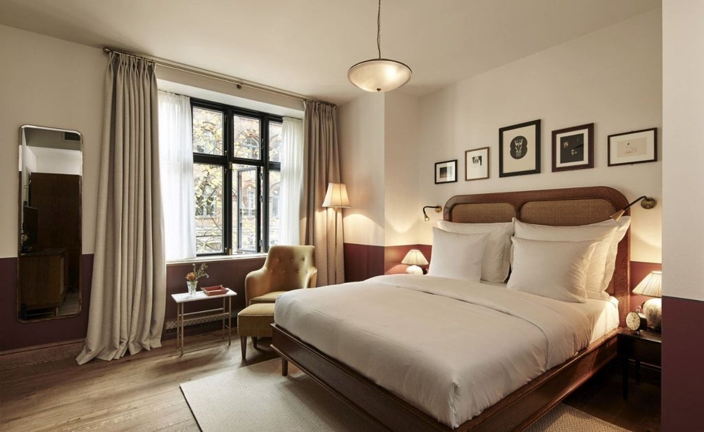 Elegant entrance to Hotel Sanders in Copenhagen with black awning, brass fixtures, and classic Danish architectural details