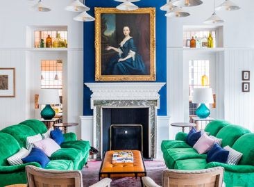 Luxurious seaside hotel with white facade, blue-green coastal backdrop, traditional British architectural charm in scenic Southwold coastal setting