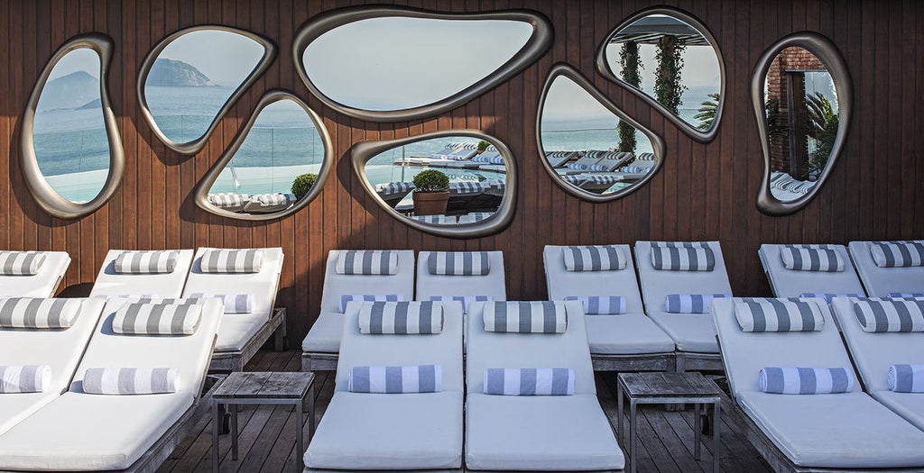 Five-star Hotel Fasano Rio de Janeiro with infinity pool overlooking Ipanema Beach, featuring modern architecture and ocean views at sunset