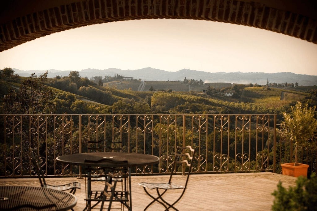 Luxurious Italian hotel nestled among rolling Tuscan hills, featuring elegant stone facade, manicured gardens, and panoramic countryside views at sunset