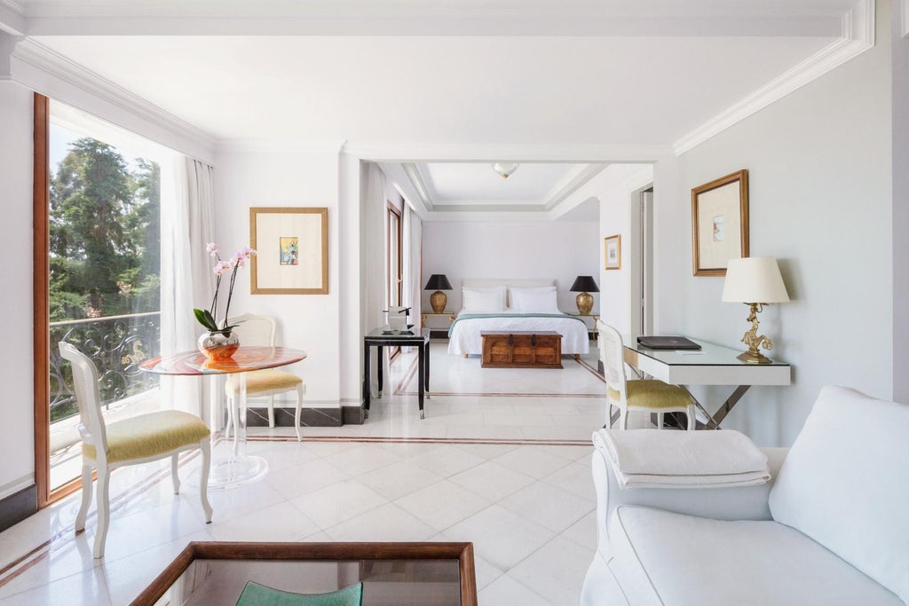 Luxurious Danai Suite with panoramic Aegean Sea view, featuring elegant white interiors, plush king bed, and private balcony overlooking turquoise waters of Greece.