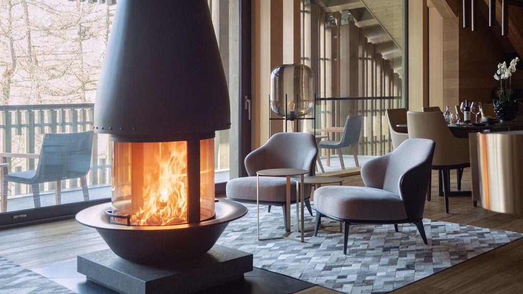 Elegant Gotthard Suite at The Chedi Andermatt, featuring Swiss Alpine luxury with minimalist design, warm wood tones, and panoramic mountain views.