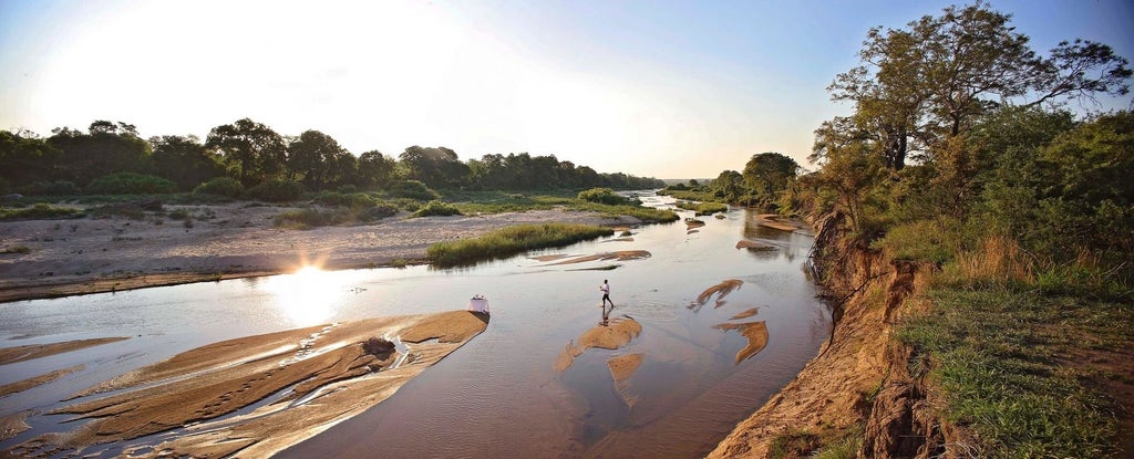 Elegant open-air luxury suite at Dulini River Lodge with private plunge pool overlooking African wilderness and riverbed views