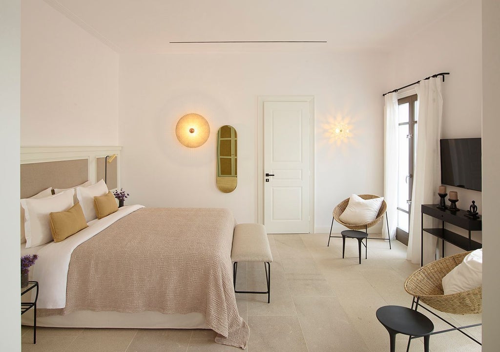 Luxurious one-bedroom suite in Mykonos with private heated pool, overlooking azure Aegean Sea, featuring elegant contemporary design and sun-drenched balcony