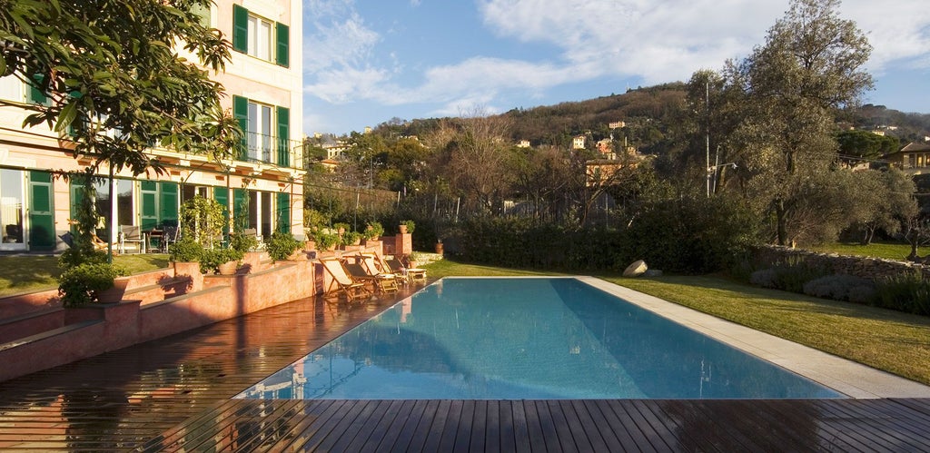 Elegant boutique hotel nestled in lush Italian countryside, Villa Scenset boasts white stone walls, verdant gardens, and panoramic Tuscan landscape views