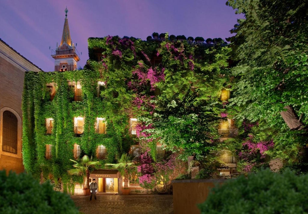 A luxurious 16th-century Relais & Chateaux hotel with classic Italian facade, elegant arched windows, and flowering vines cascading down stone walls.