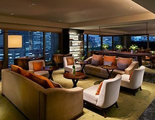 Elegant executive suite at luxury hotel in Tokyo, featuring minimalist design, panoramic city views, and sophisticated Japanese-inspired interior decor