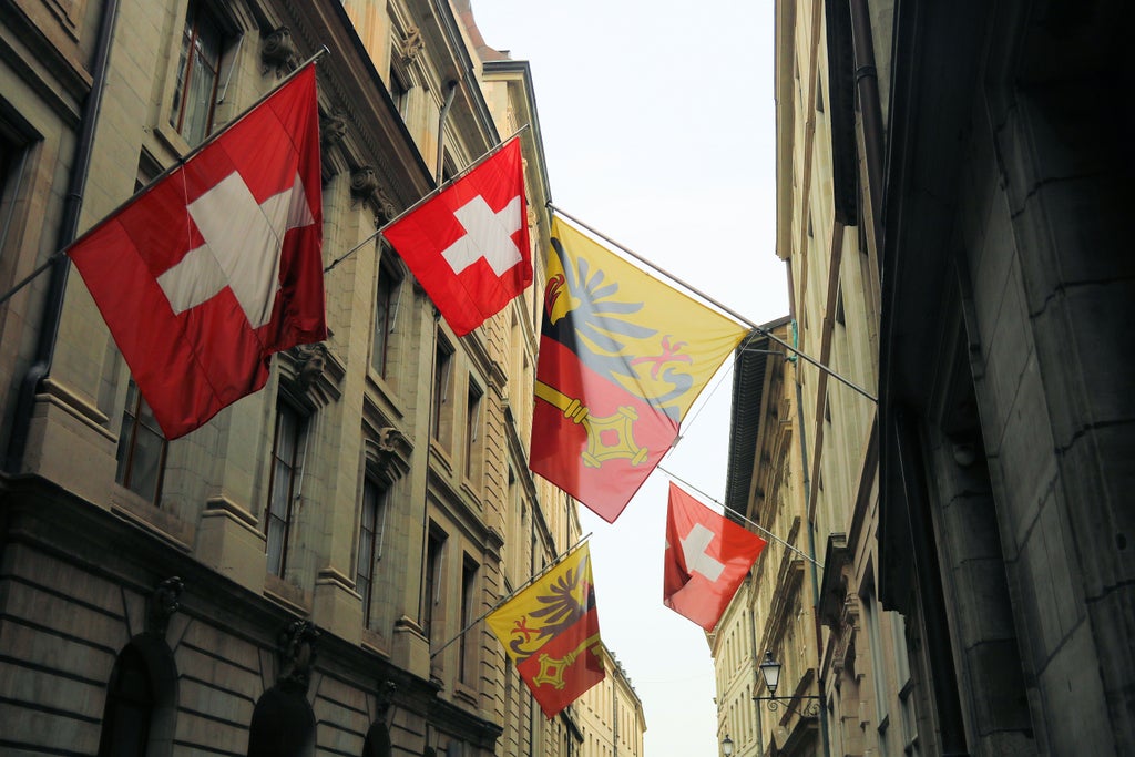 Elegant walking tour group exploring Geneva's historic Old Town, with ornate Swiss architecture, cobblestone streets, and Lake Geneva in background