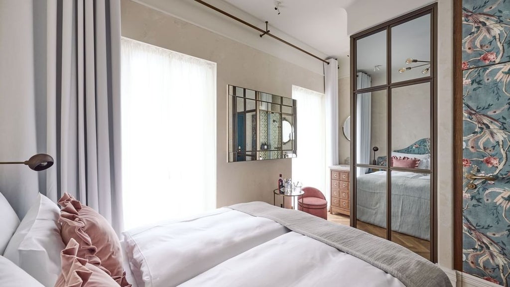 Minimalist Austrian hotel room with sleek wooden furnishings, soft gray textiles, and elegant contemporary design in warm neutral tones