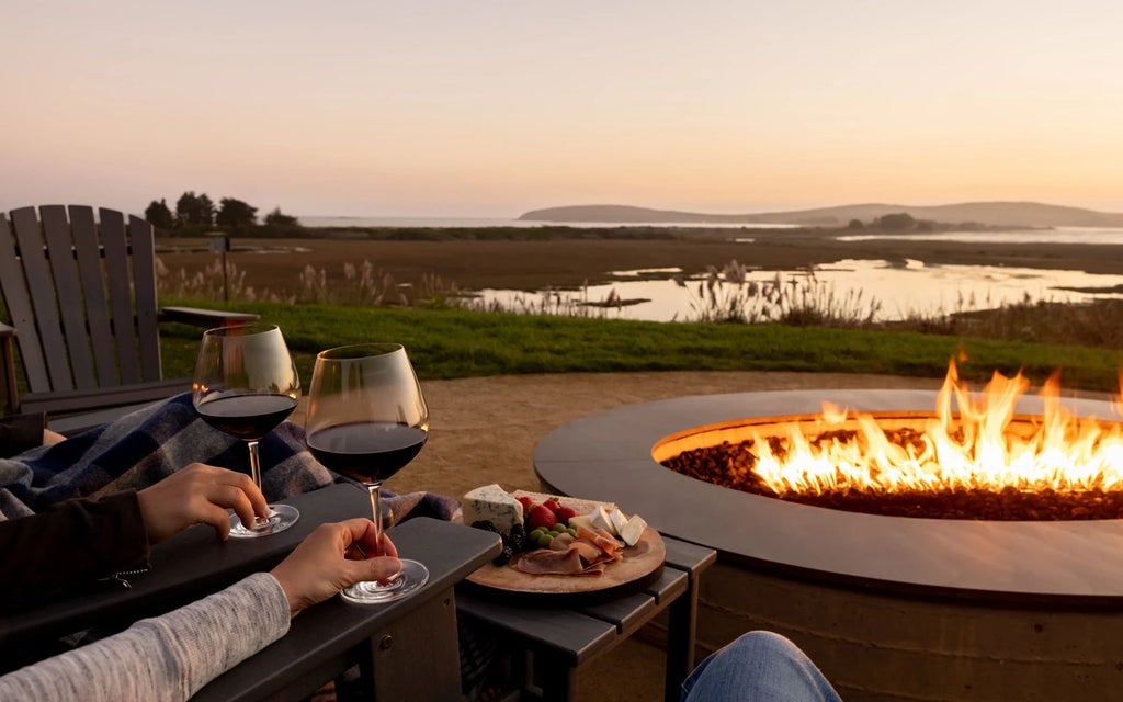 Luxurious coastal resort nestled in Bodega Bay, featuring rustic wood exterior, expansive ocean views, and elegant landscaping with native California greenery