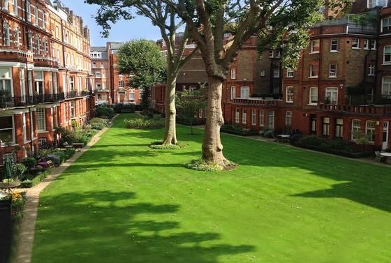 Elegant luxury hotel exterior with classic British architecture, pristine white facade, ornate windows, and manicured entrance in a prestigious urban setting