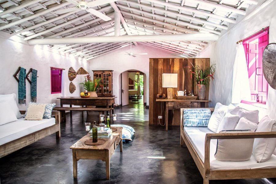 Rustic-chic wooden bedroom with artisan furnishings, soft neutral palette, and tropical Brazilian charm at UXUA Casa Hotel's historic Trancoso suite