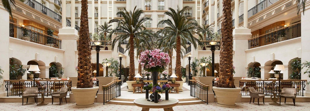 Elegant five-star Victorian hotel facade with grand arched entrance, ornate stonework, and classical columns in Marylebone, London