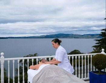 Luxurious waterfront villa with panoramic lake and mountain views, featuring modern architectural design and floor-to-ceiling windows at New Zealand's scenic resort