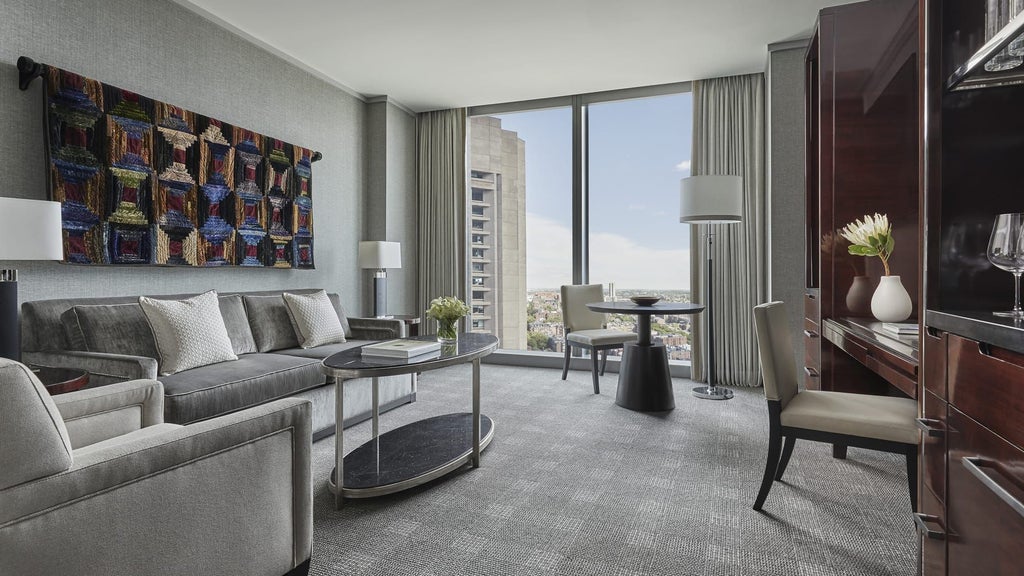 Spacious Four Seasons accessible suite in Boston's Back Bay, featuring elegant furnishings, wide doorways, and sophisticated mobility-friendly design with city views