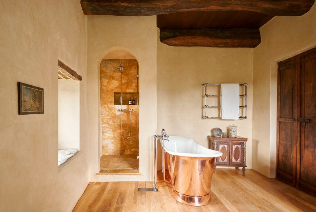 Elegant rustic-chic suite with stone walls, wooden beams, and panoramic Tuscan countryside view from private terrace at Castello di Vicarello