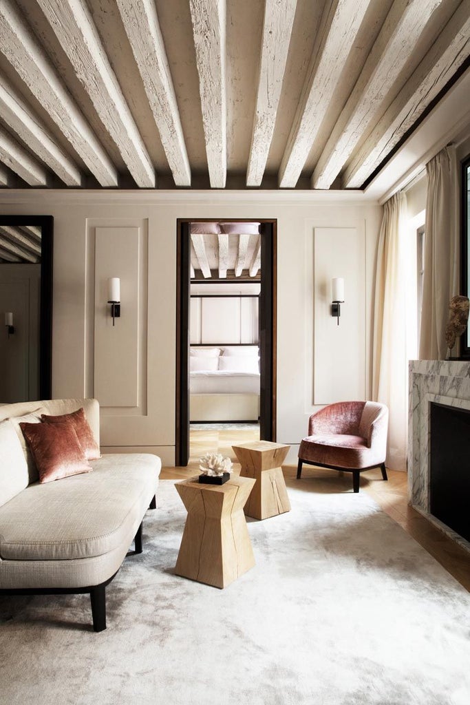 Elegant Venetian suite with high ceilings, ornate chandelier, plush king bed, rich velvet drapes, and historic architectural details in warm golden tones.