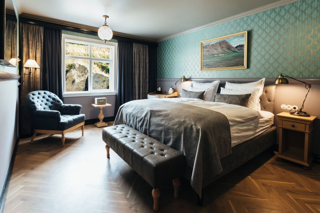 Elegant Icelandic manor hotel standard single room with wooden furnishings, crisp white linens, and minimalist Nordic design aesthetic