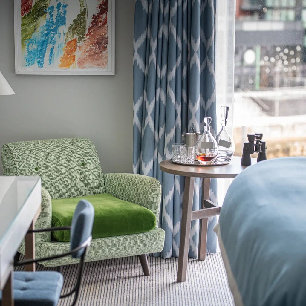 Spacious marina view suite with elegant balcony, contemporary furnishings, panoramic waterfront vista, and modern maritime-inspired design in Southampton hotel