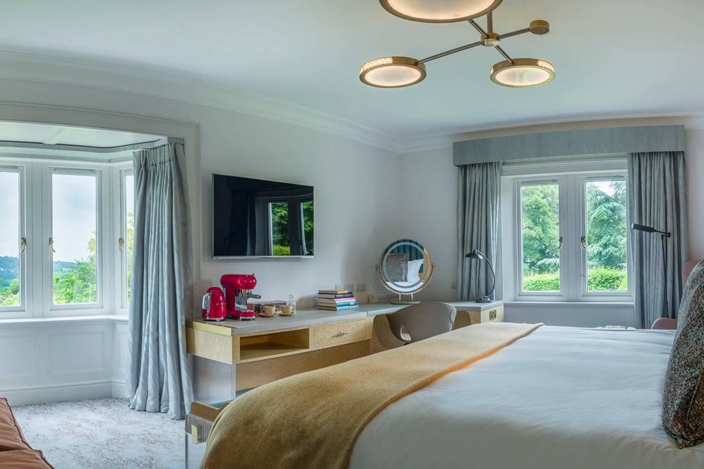 Elegant Homewood Hotel & Spa room with plush king bed, contemporary neutral decor, large windows, and sophisticated seating area in United Kingdom