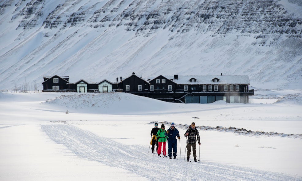 Luxurious Icelandic heli-skiing lodge nestled in snow-capped mountains, pristine white landscape with Nordic-style architecture and modern comfort