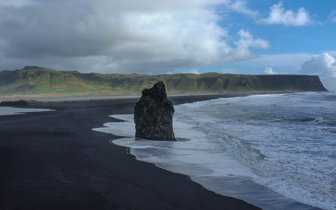 Let your toes sink into the black sand at Reynisfjara