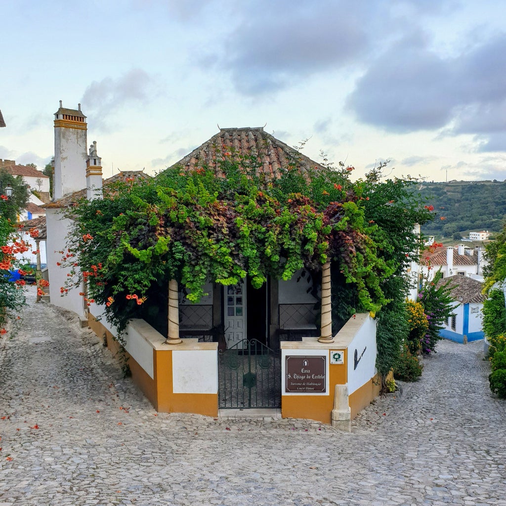 Medieval whitewashed town Obidos, with narrow cobblestone streets, historic stone fortress walls and traditional Portuguese architecture.