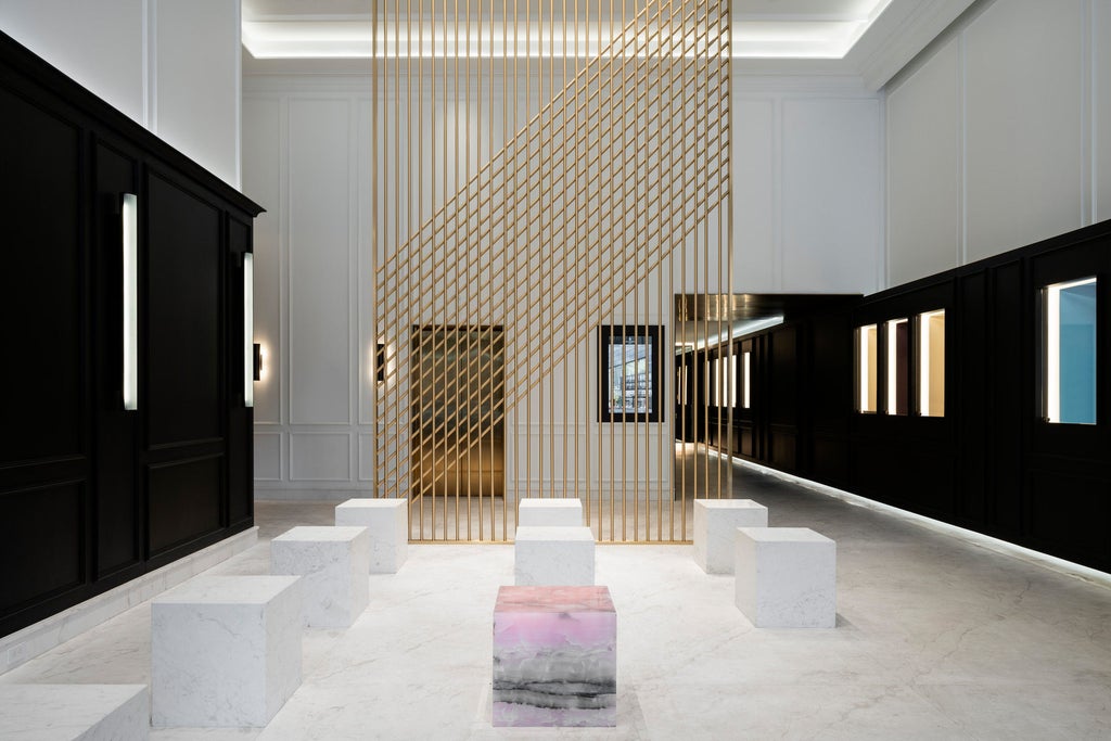 Elegant Four Seasons Montreal facade with modern glass architecture, warm lighting, and sleek contemporary entrance beneath illuminated hotel logo