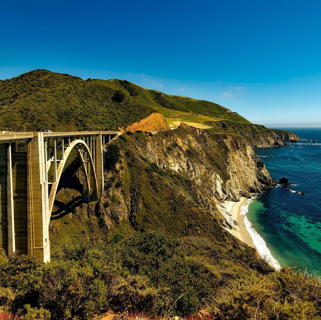 Luxurious safari-style glamping tent nestled in Big Sur forest with private deck, outdoor furniture and panoramic wilderness views