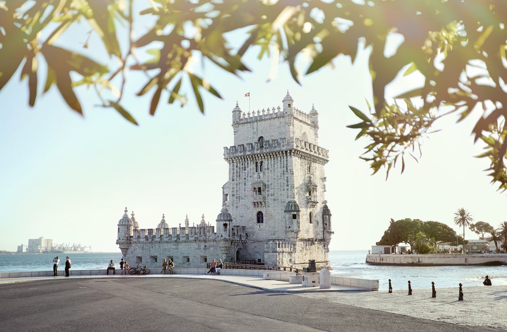 Classic Portuguese architecture in Lisbon's historic center with pastel-colored buildings, ornate balconies and cobblestone streets at sunset