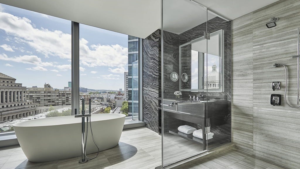 Spacious Charles Suite at scenset Four Seasons Hotel with elegant king bed, city view windows, and contemporary luxe design in Boston's Back Bay area