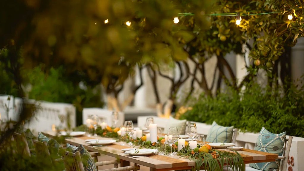 Luxurious whitewashed Mediterranean villa with terracotta roofs, surrounded by lush gardens and blue sky at Scenset Vila Monte in Algarve, Portugal