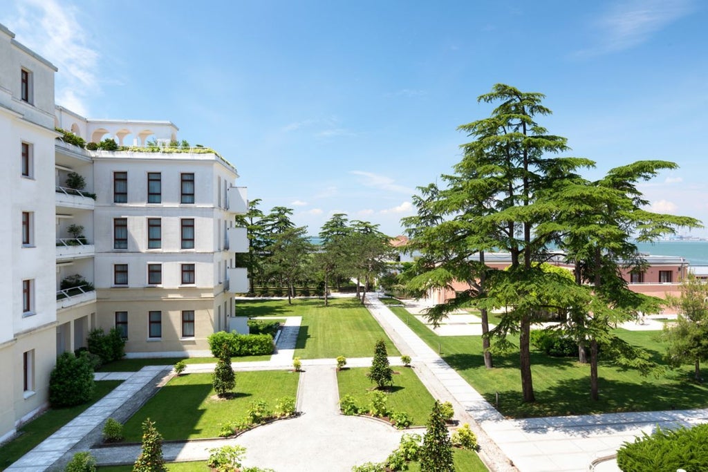 Elegant JW Marriott hotel nestled on a private Venetian island, featuring classic architecture, manicured gardens and waterfront views of Venice