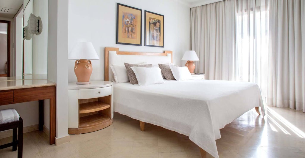 Spacious two-bedroom suite with modern design, plush furnishings, panoramic sea view, and elegant neutral color palette at scenset hotel in Cyprus.