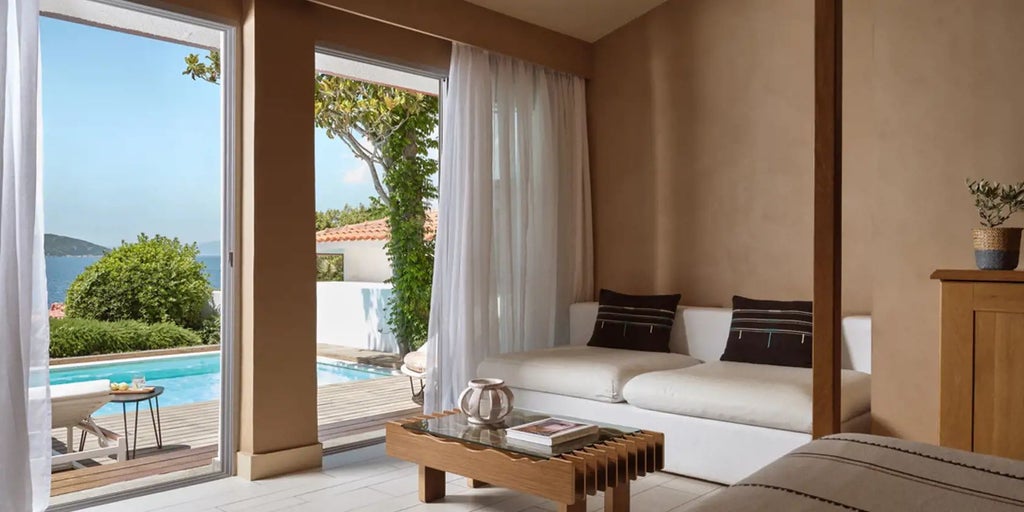 Luxurious two-bedroom bungalow with panoramic Aegean Sea views, private infinity pool, and elegant Mediterranean design at Eagles Palace resort, Greece.