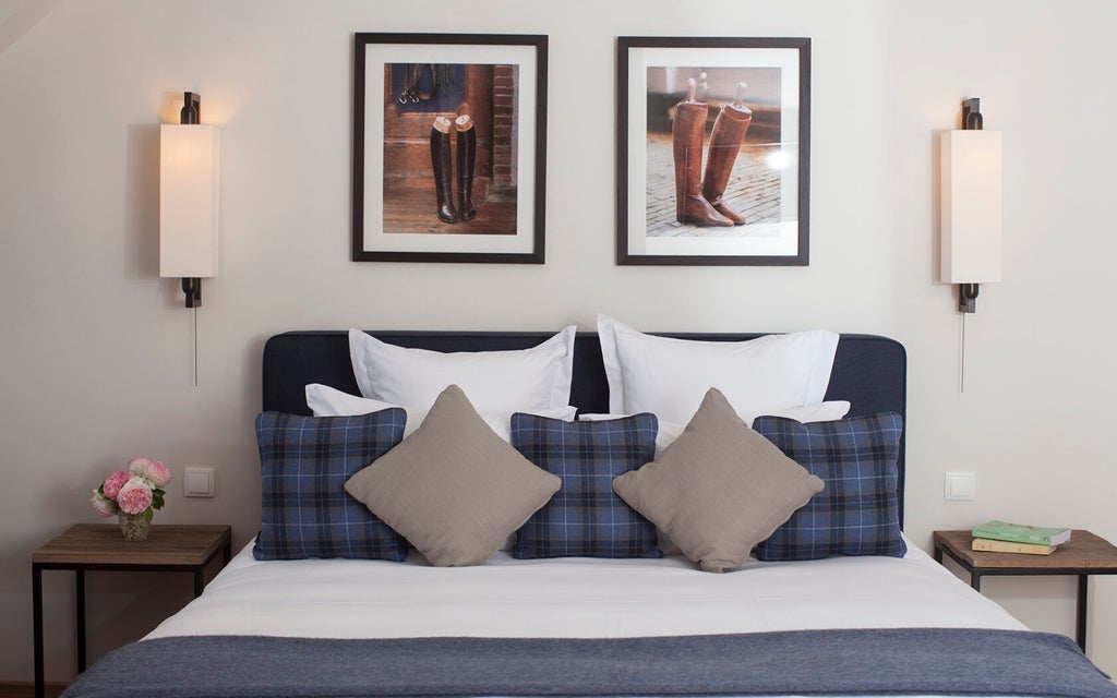 Elegant French hotel suite with soft seafoam green and marine blue decor, antique furniture, luxurious king bed, and delicate natural light streaming through tall windows